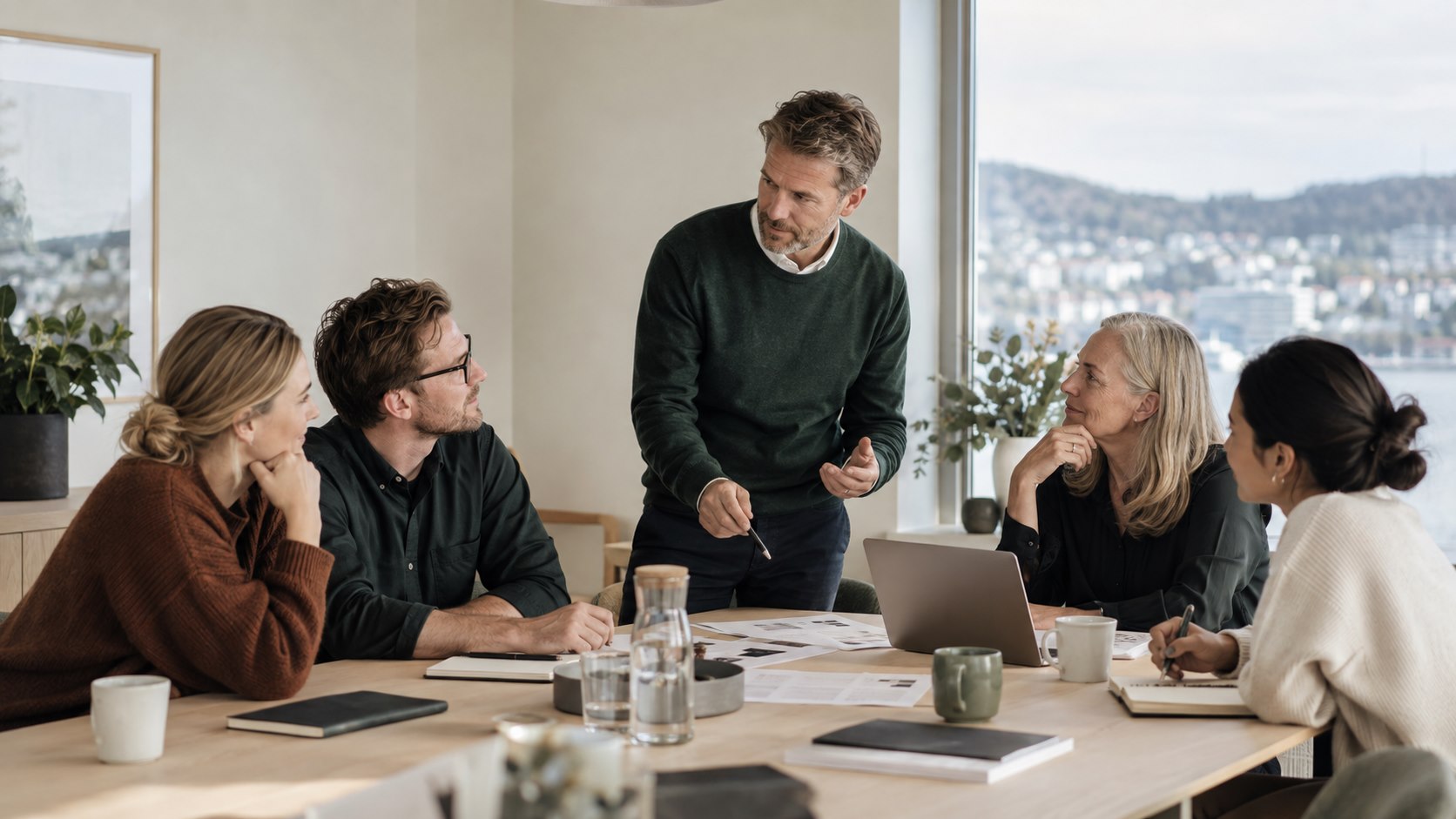 Rådgiver leder et praktisk arbeidsverksted med medarbeidere rundt et møtebord